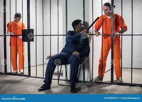 A Security Guard In A High Security Prison Threatens A Prisoner In Solitary Confinement With