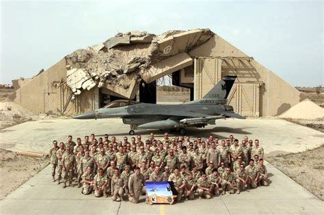 Deployed Members Of The 185Th Fighter Wing Pose With Their F 16C Fighting Falcon In Front Of A