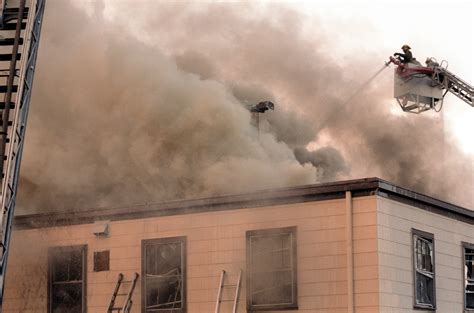 Firemen On A Fire Engine Tower Ladder Fight A Fire Which Is Burning The Chief Of Chaplains