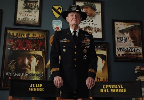 Lieutenant General Hal Moore Posing In Front Of Posters For The Movie We Were Soldiers The