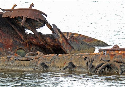 The Rusted Hull Of The Uss Utah Remains In The Water Just Off Ford