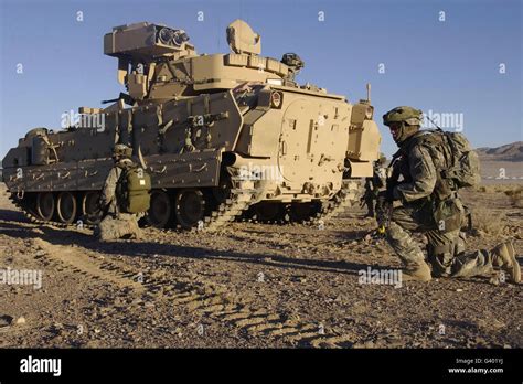 U S Army Soldiers Provide Security With An M2 Bradley Fighting Vehicle