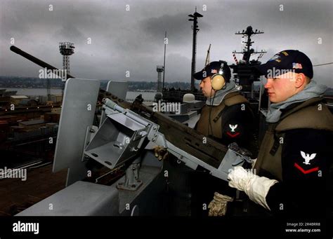 Us Navy Gunner Amp 39 S Mate 3Rd Classes Stand A 50 Caliber Watch Aboard The Nimitz Class Aircraft