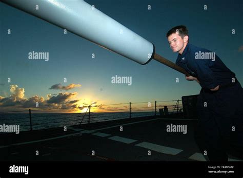 Us Navy Gunner S Mate 3Rd Class Cleans The Barrel Of A Mk 45 5 Inch 54 Caliber Lightweight Gun