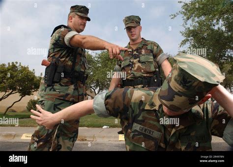 Us Navy Master At Arms 1St Class Timothy Fite Instructs Hull Technician 2Nd Class Brad Hurshey