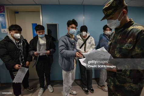 Young Men Line Up With Their Physical Examination Sheets To Under Go A Physical Examination